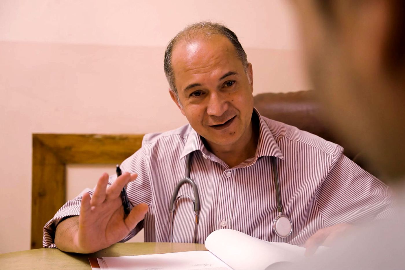 Dr. Denis Shrestha talking with a patient