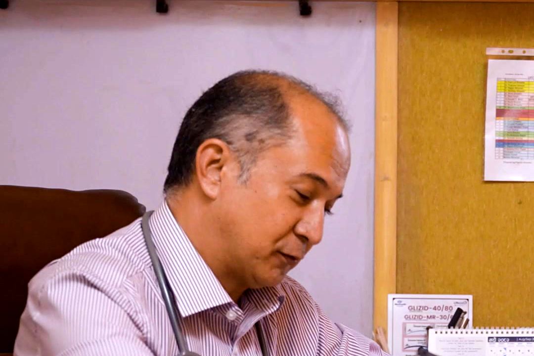 A doctor reviewing a patient’s reports
