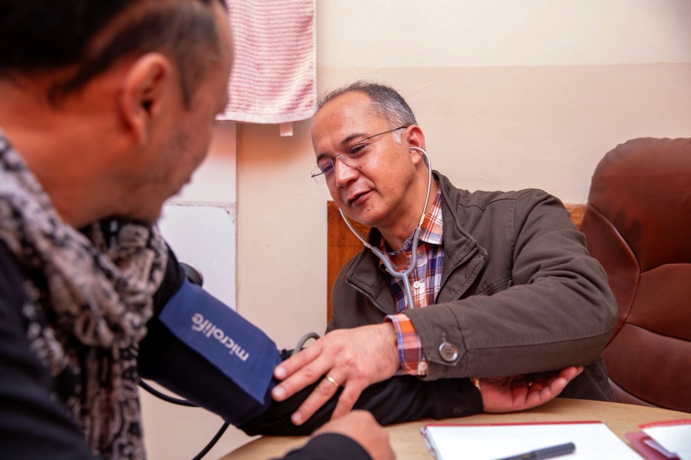 A physician checking a patient’s blood pressure