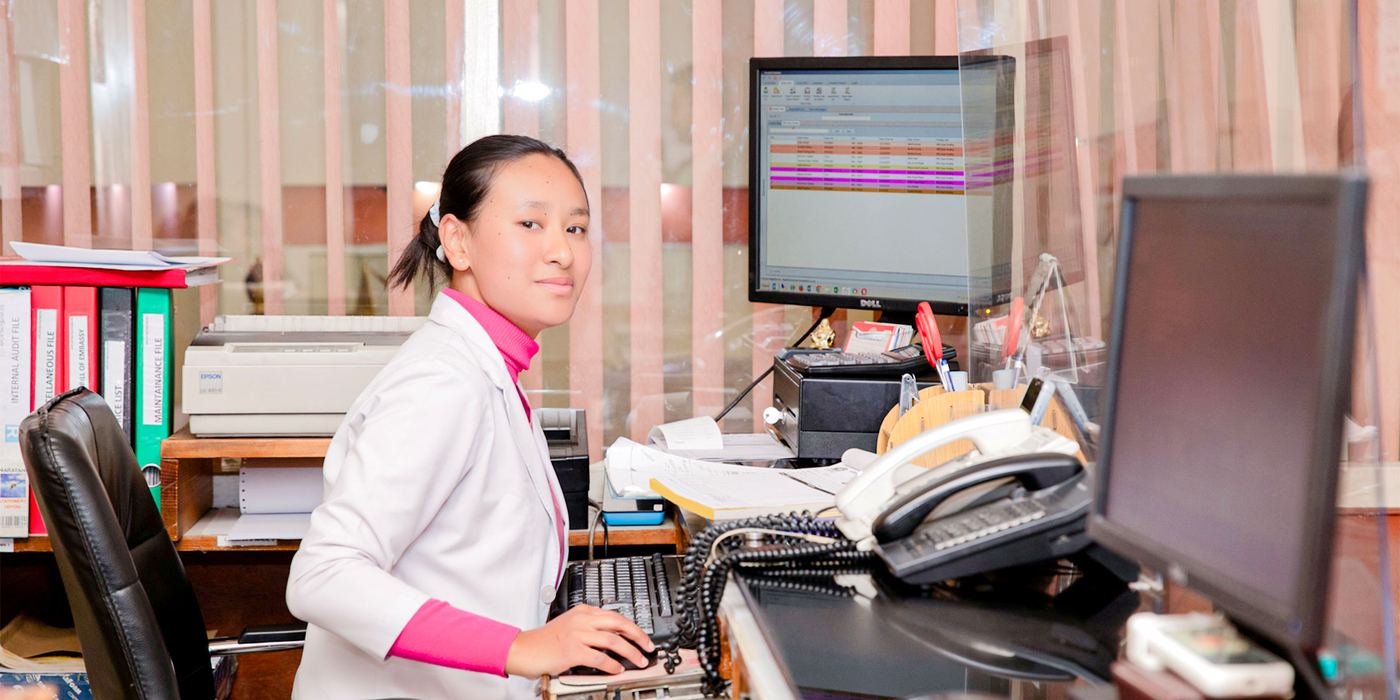 A receptionist at the APC front desk